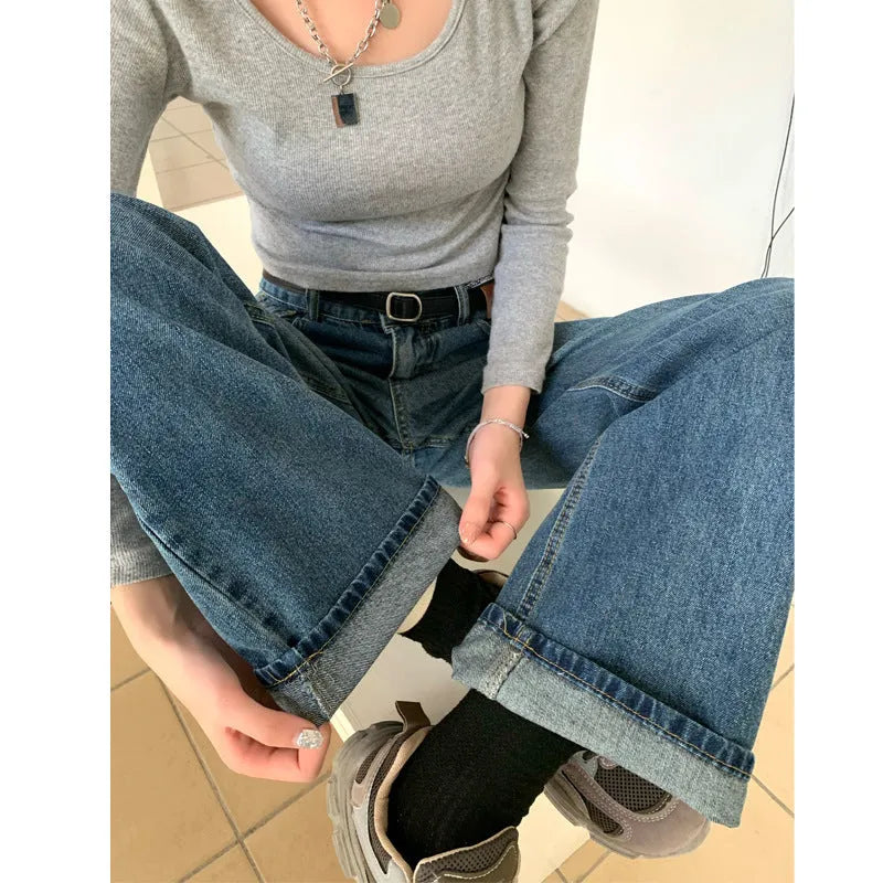 Women's retro blue high waist straight leg jeans on a hanger, showing the classic denim cut.