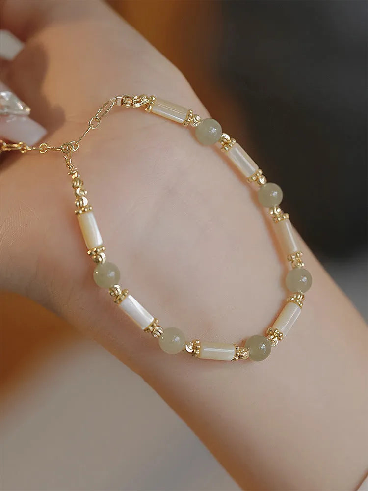 Women's Hetian jade bracelet with bamboo joint design in jade green and red colour options.