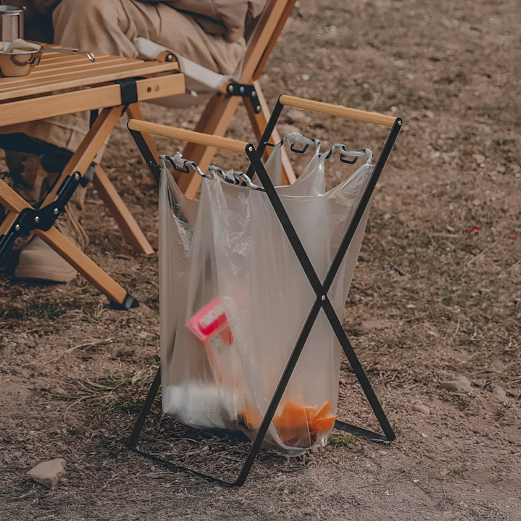 Foldable outdoor trash rack with wooden handle in black or white colour