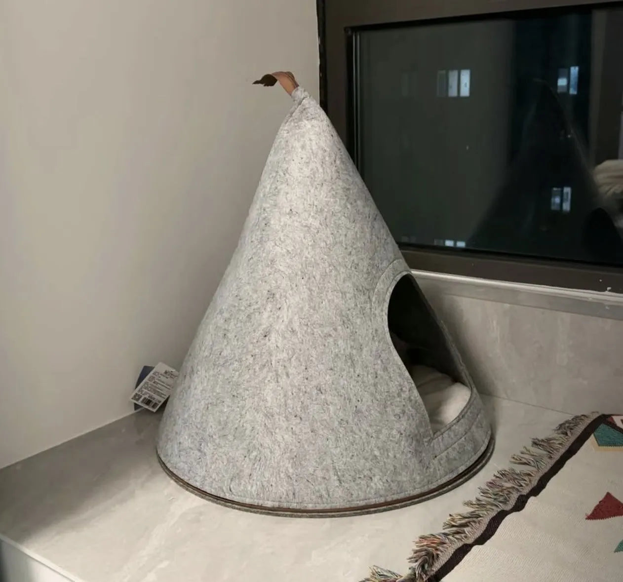 Grey cone-shaped felt cat house measuring 50cm wide with enclosed tent design
