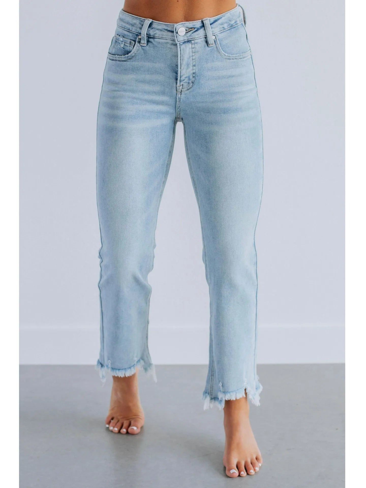 Women's solid blue casual denim trousers with a hand-worn finish on a hanger.