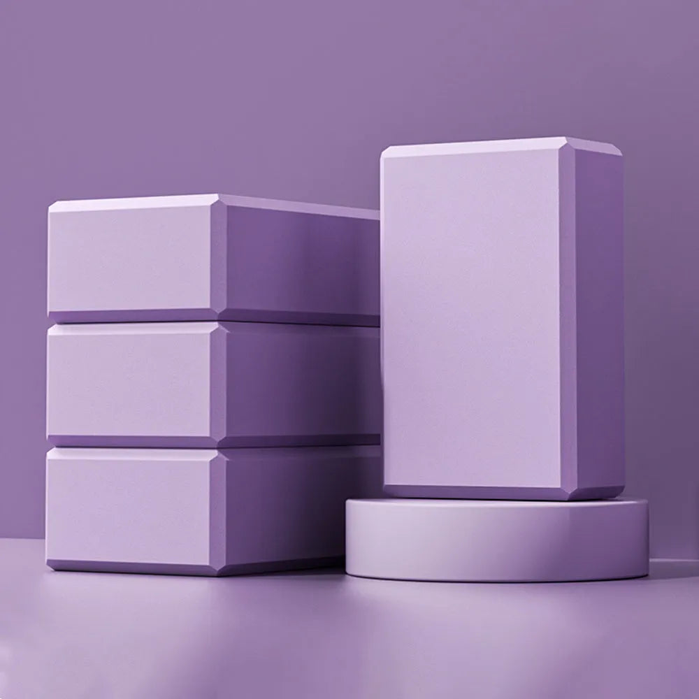 Solid colour high-density EVA yoga block on a gym floor.