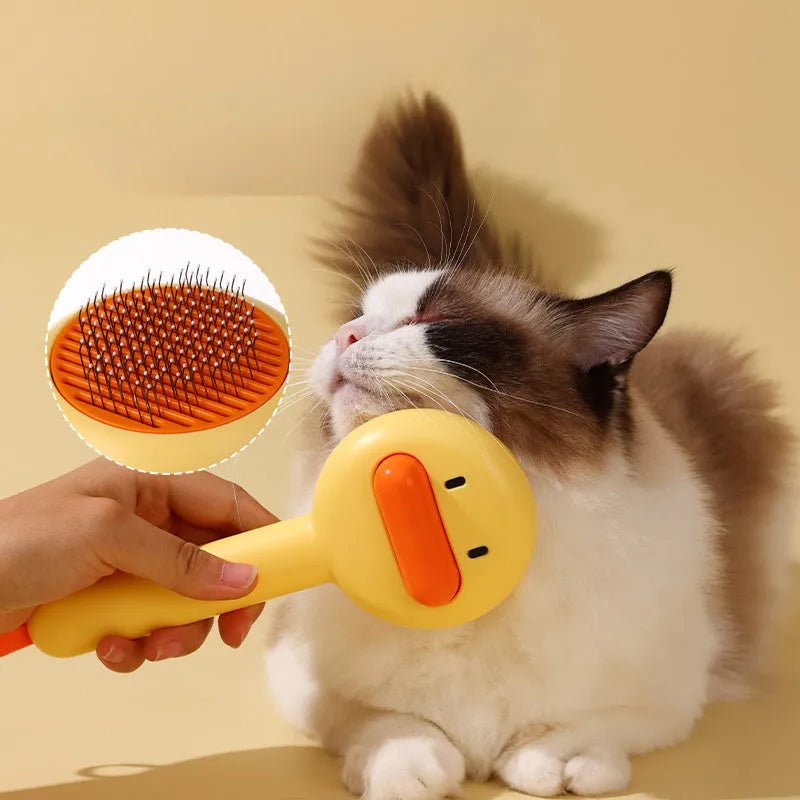 Small yellow duck-shaped pet grooming comb with needle pins for cats and dogs