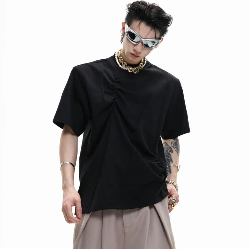 Men's black cotton T-shirt with three-dimensional pleats on the front, showing a round neck and short sleeves.