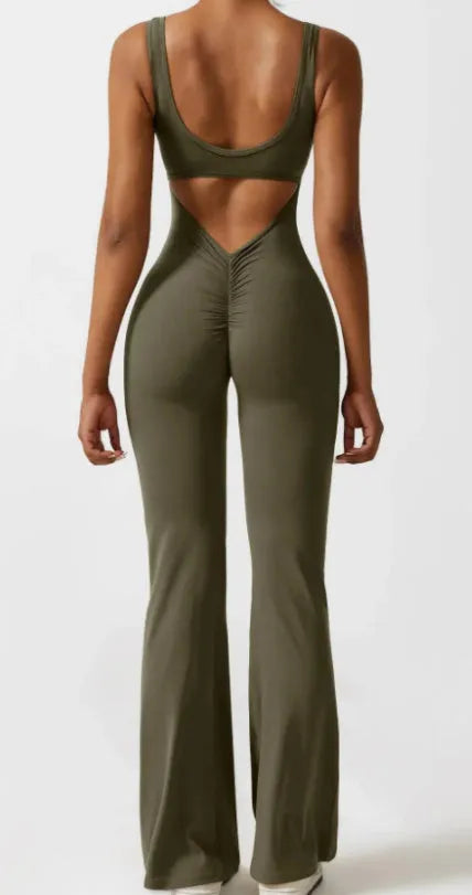 Women's black seamless yoga jumpsuit with built-in chest pad showing mid-waist design
