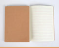 Beige leather cover thread-bound notebook open showing lined paper pages in 16K size.