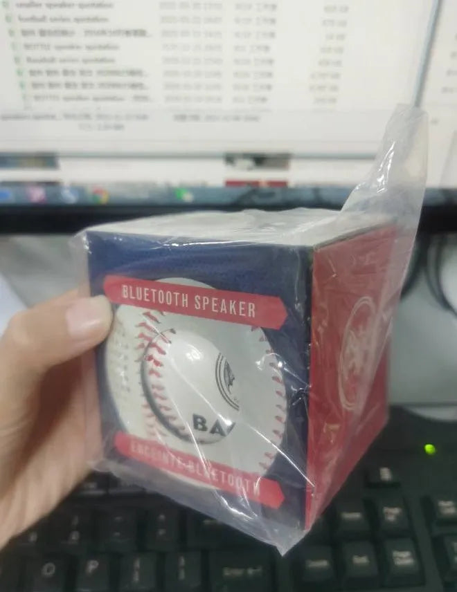 Baseball-style Bluetooth speaker in green colour showing compact design with likely control buttons.