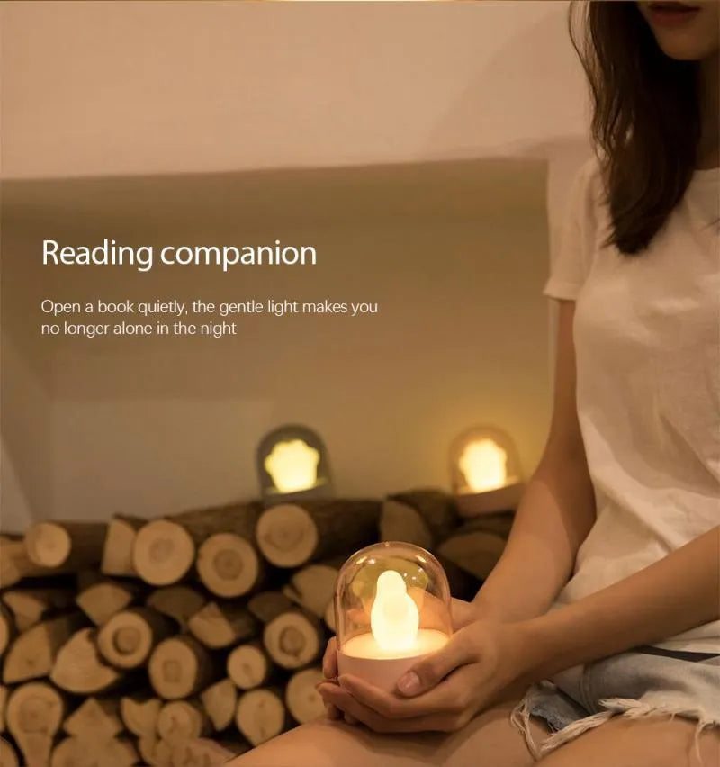Grey cat paw USB charging music box night light with adjustable brightness on wooden desk