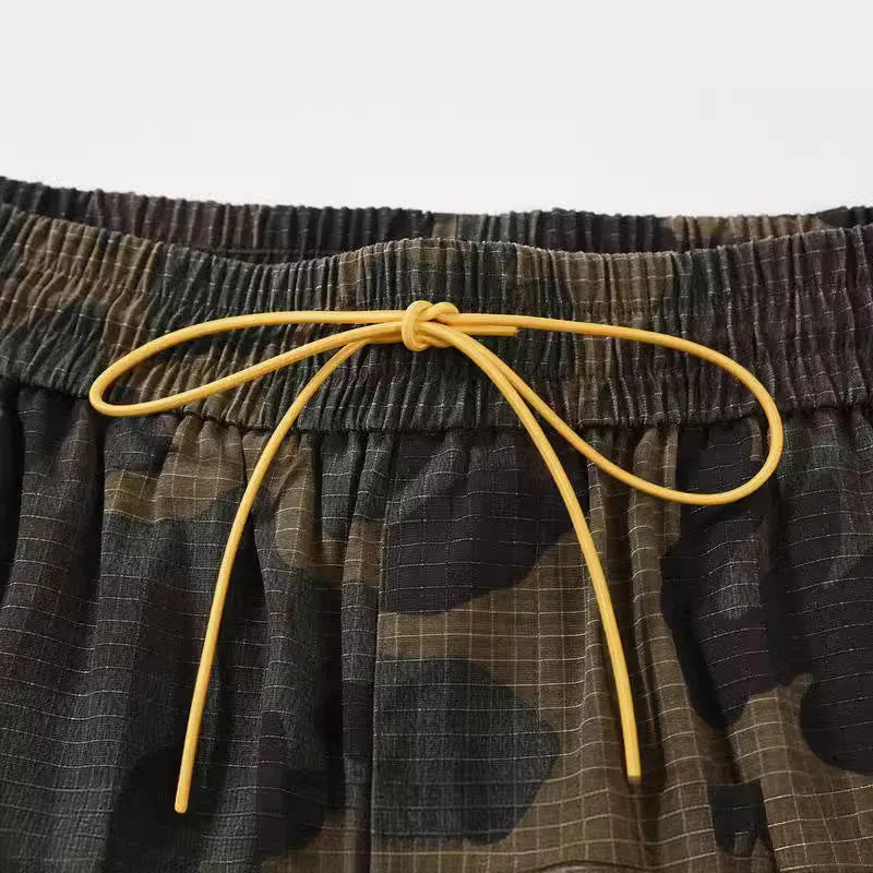 Men's green camouflage cotton work shorts with a loose fit, shown on a mannequin