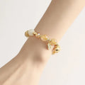 Korean style gold bracelet with rutilated quartz crystal charms on an electroplated chain.