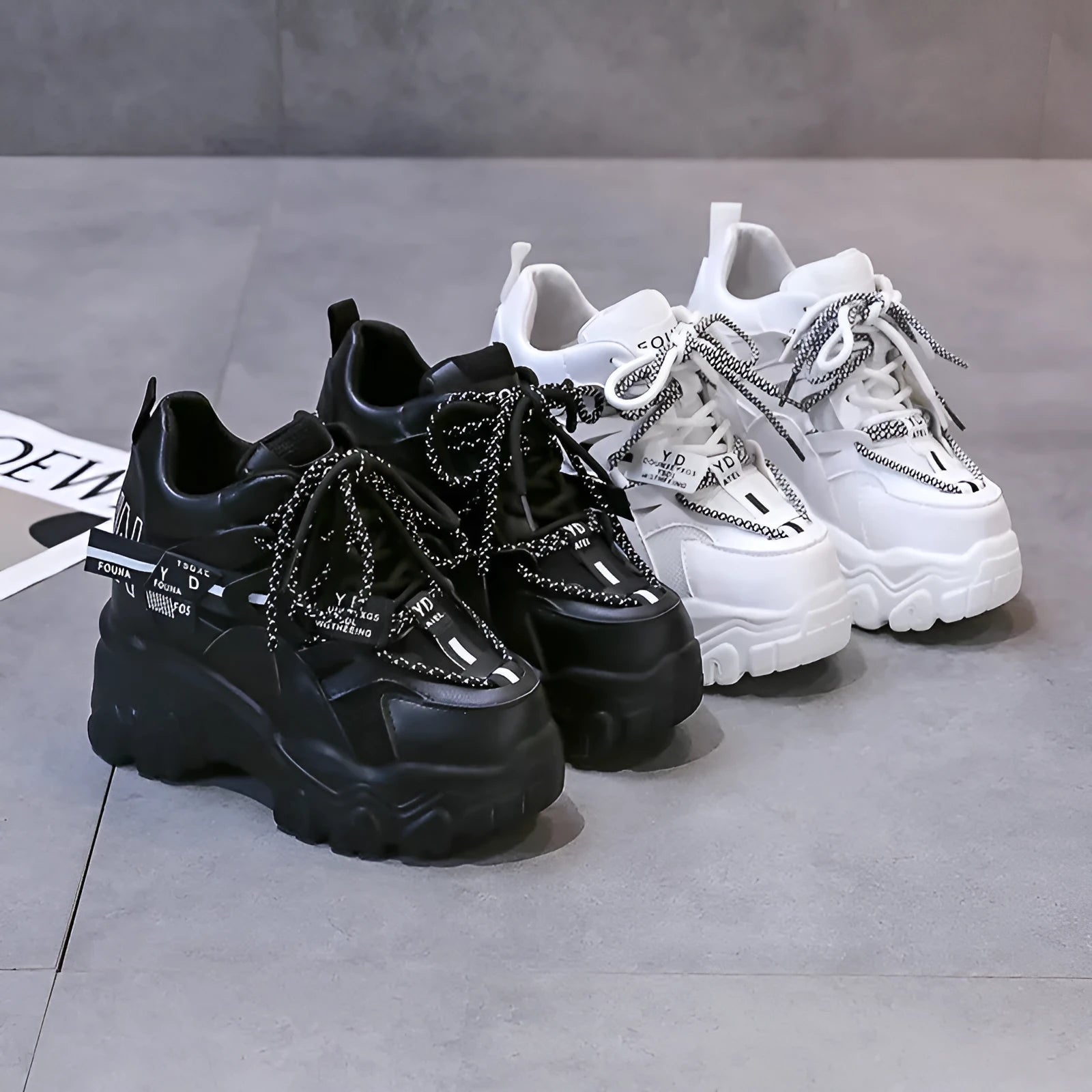 White women's platform sports shoes with mesh upper, cross strap, and a thick rubber sole.