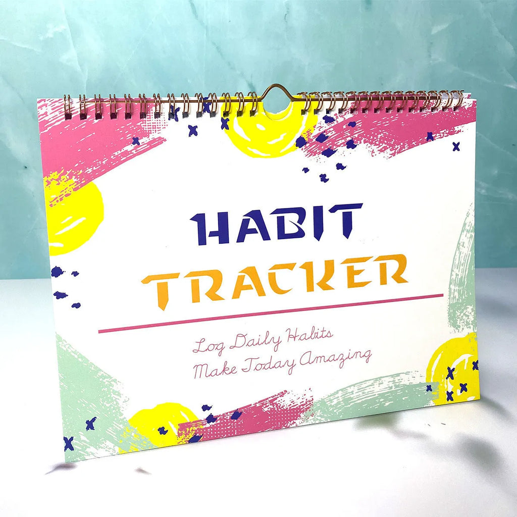 A4 habit tracking book with coloured cover open to show interior pages