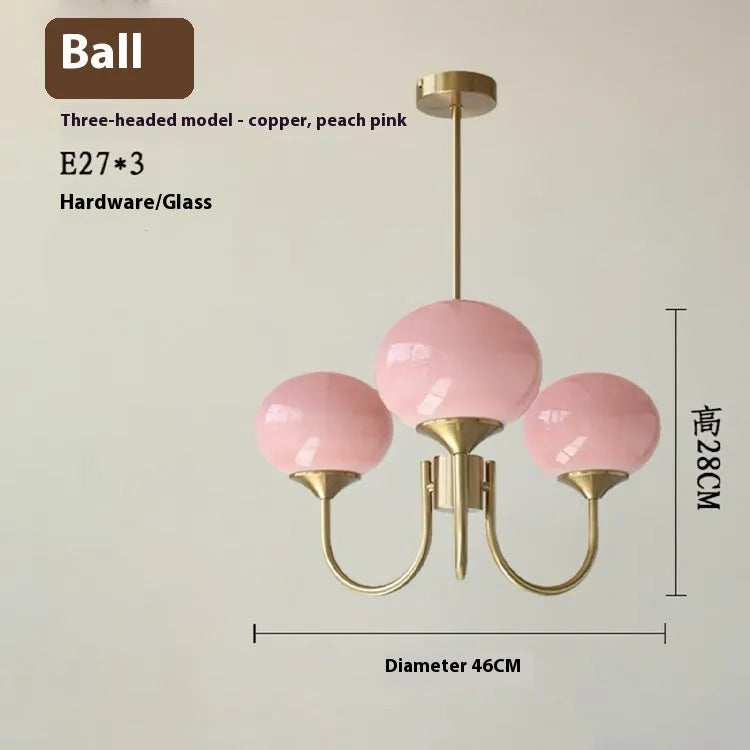 Three-head chandelier with iron frame and glass ball lampshades in copper finish