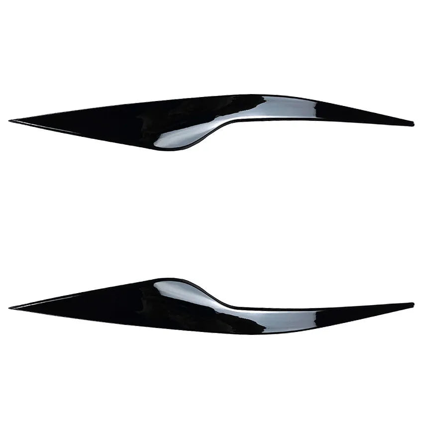 Two ABS plastic headlight eyebrow stickers for Ford Focus in carbon fibre and piano black finishes.