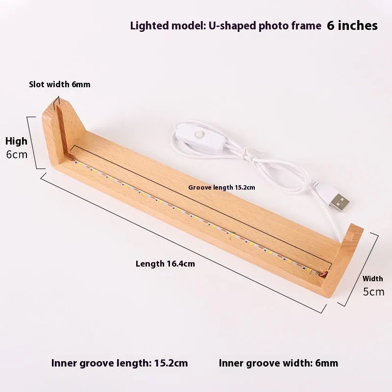 Wooden U-shaped luminous display stand with warm light holding a photo on a desk