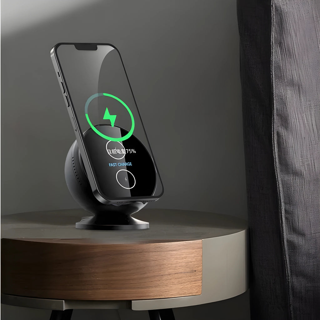 A black multifunctional wireless charging phone holder with integrated Bluetooth speaker on a desk.