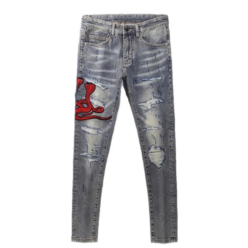 Men's slim fit vintage jeans with a washed-out colour and distressed hole patch embroidery.