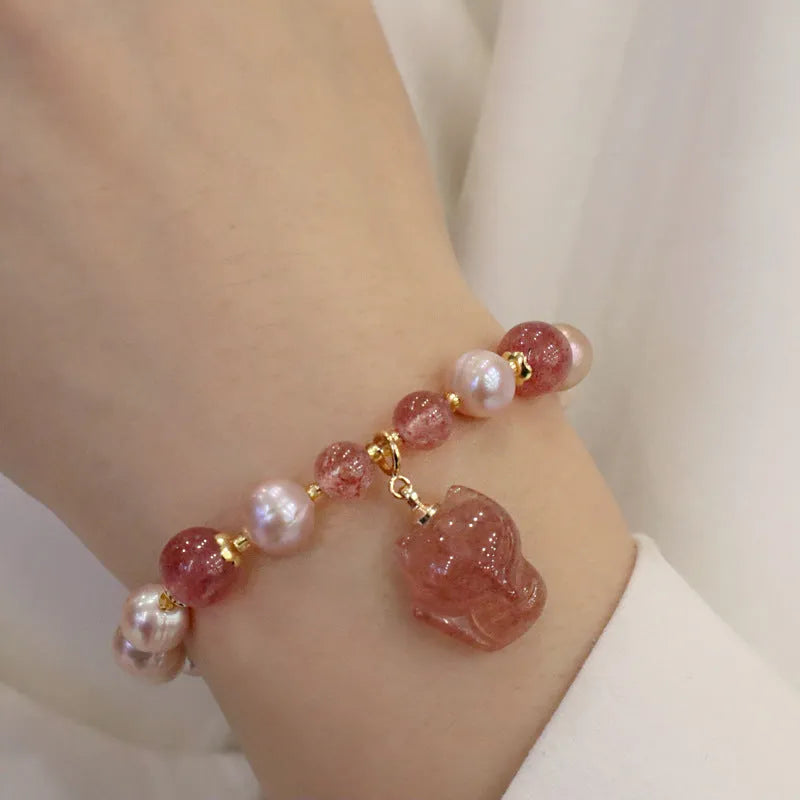 Light pink freshwater pearl bracelet with silver fox charm and strawberry quartz detail on adjustable strand