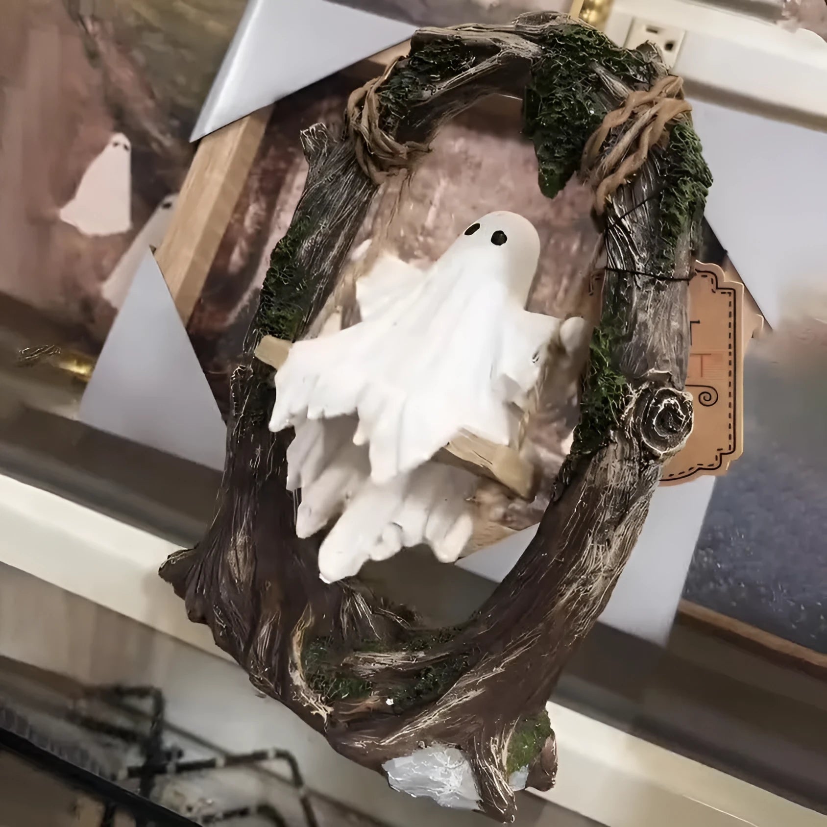 Grey resin Halloween ghost swing ornament with modern art design on display