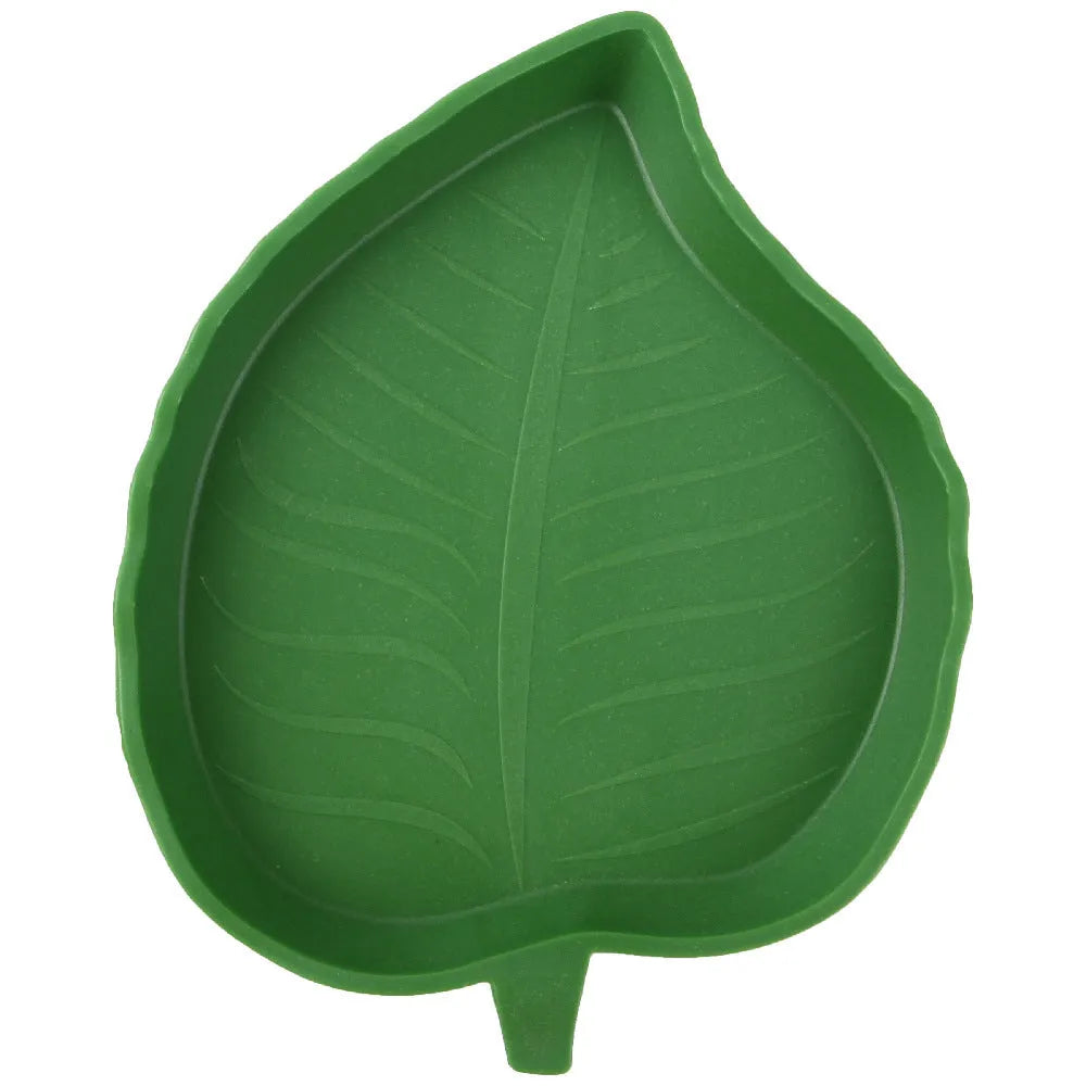 Two leaf-shaped reptile food and water bowls in green, large and small, on a white background.