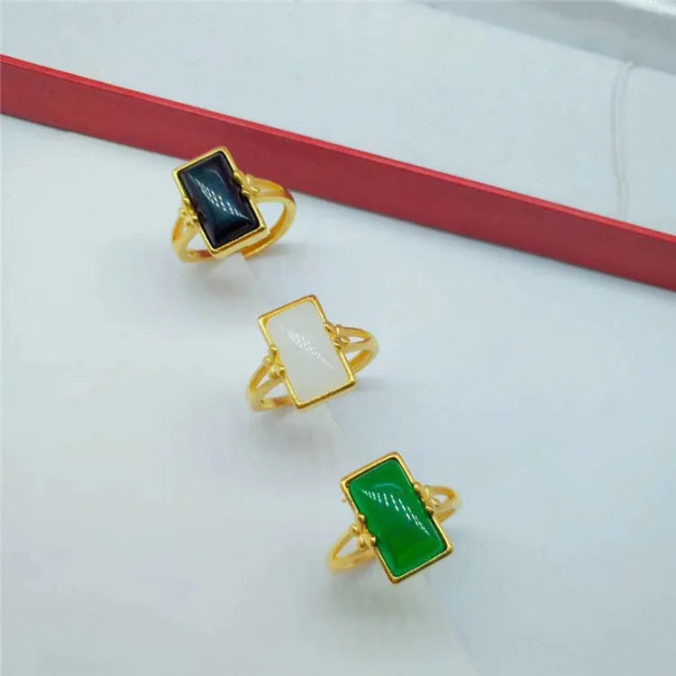 Adjustable brass gold-plated ring with a long green gemstone in a national style setting.