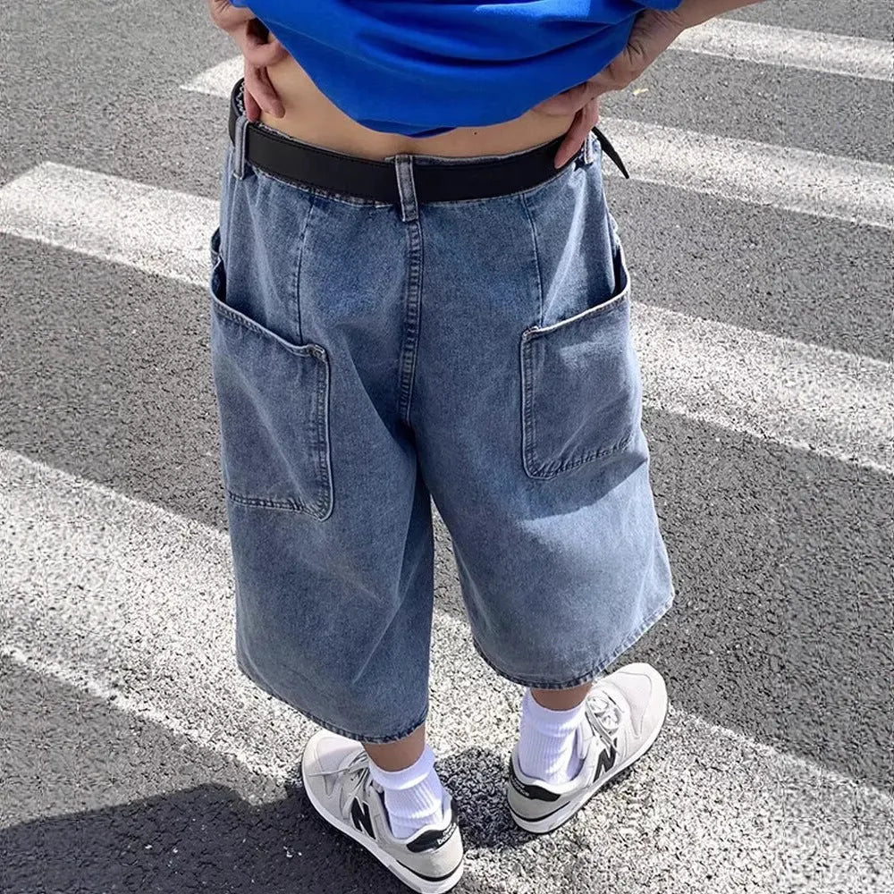 Blue washed denim pirate shorts for men with a high waist, cropped length, and straight legs on a zipper fly.