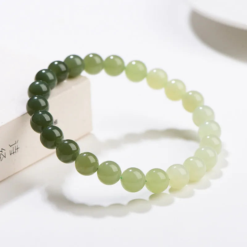 Natural clear water Hetian jade ball bracelet with gradient beads in round or barrel style.