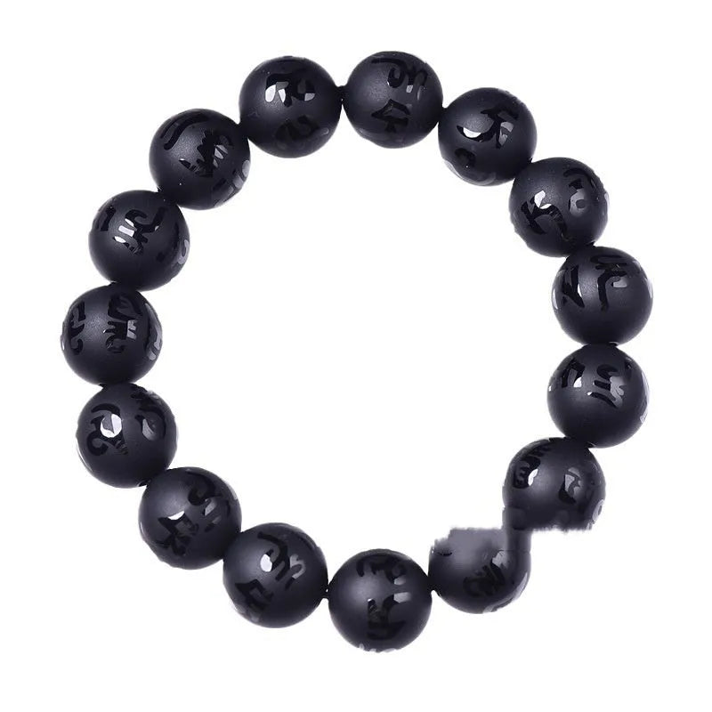 Natural frosted black agate Sanskrit mantra bracelet with Chinese auspicious patterns on a wrist.