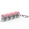 4-key mechanical keyboard switch tester in assorted colours on a desk