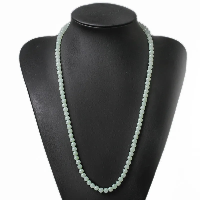 Women's adjustable jade bead necklace with round white green beads on a chain.