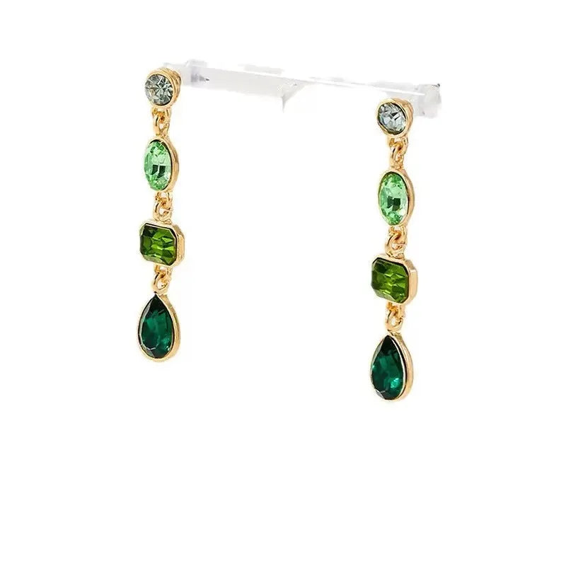 Female green round tassel long geometric earrings on display showing round acrylic and tassel drop