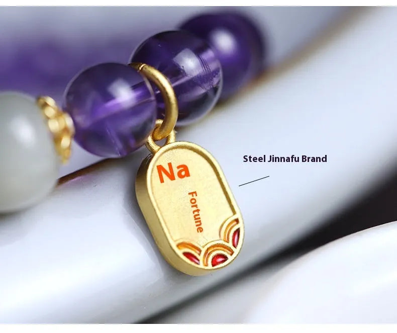 Close-up of a women's bracelet with purple amethyst crystal geometric beads measuring 8mm