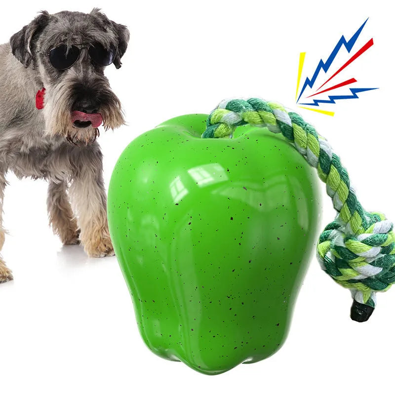 Green and red plastic dog dental toy ball with food-dropping feature and molar-shaped texture