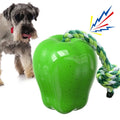 Green and red plastic dog dental toy ball with food-dropping feature and molar-shaped texture