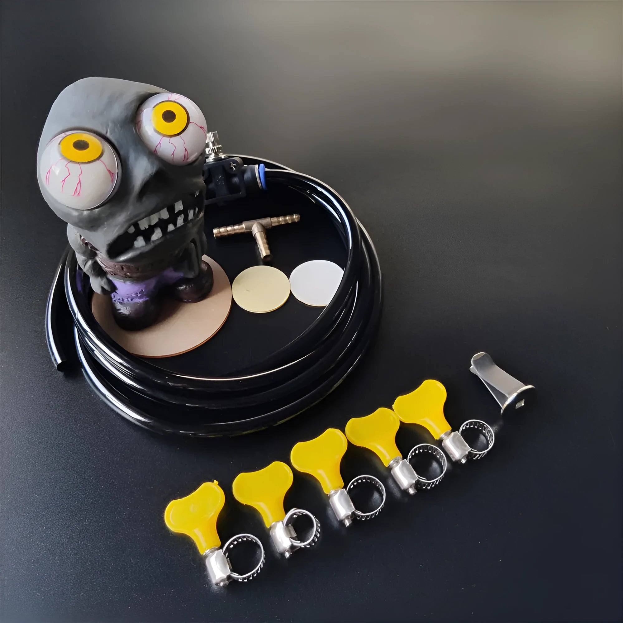 Turbo car explosive eye doll ornament and pressure valve kit with copper fittings on a white background.