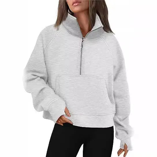 A woman wearing a loose-fitting apricot-coloured fleece-lined sweater with a lapel neckline and raglan sleeves.