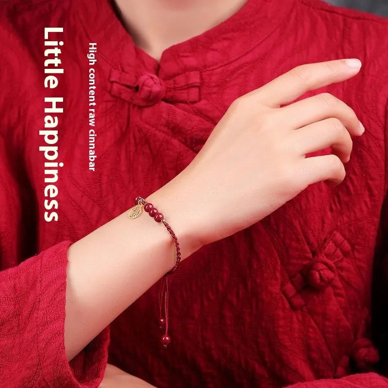 Cinnabar braided rope bracelet with blessing card, shown in black, red, or wine red with round bead or flower charm.