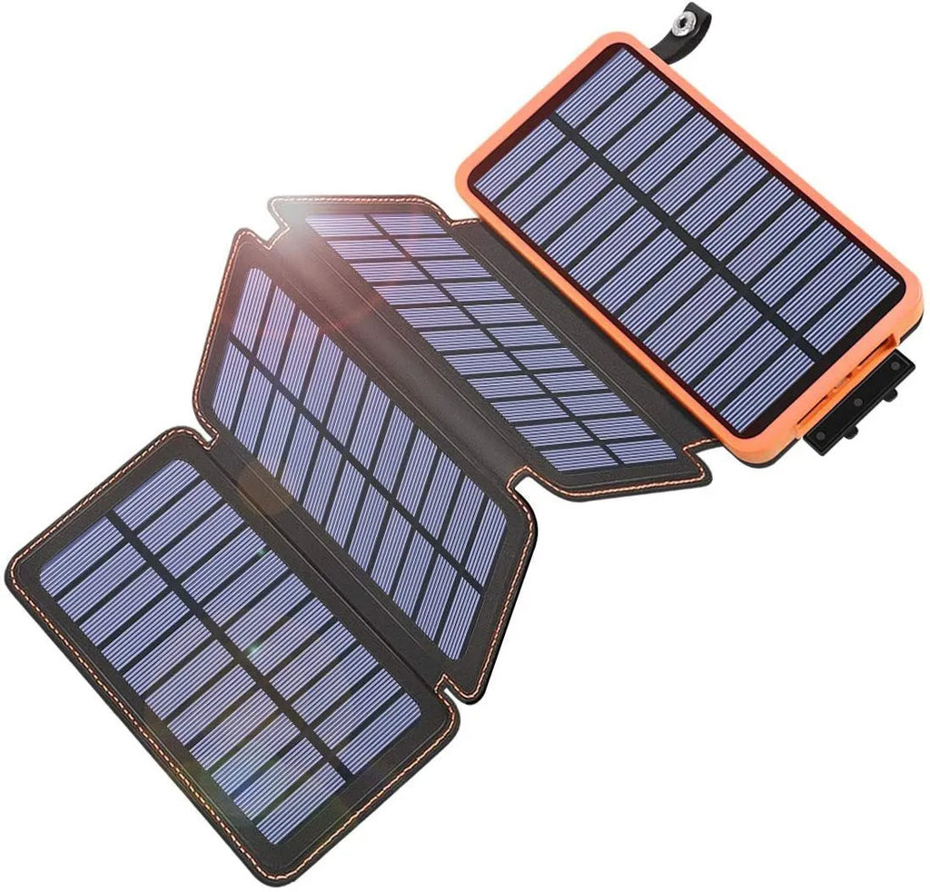 Black outdoor solar power bank with a solar panel and a built-in LED light displayed on a rock.