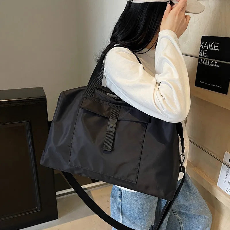 Grey one-shoulder travel bag with 36-55L capacity showing Oxford cloth construction
