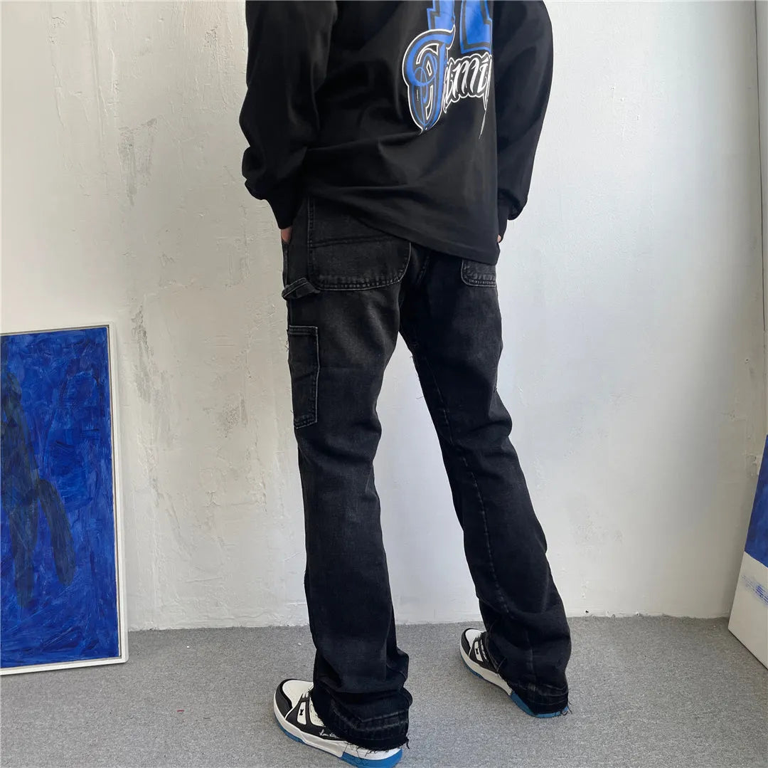 Black micro flared patchwork raw edge jeans on model showing loose straight tube fit