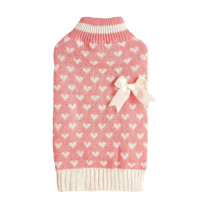 Red dog jumper with a white love heart and bow design on a small dog.