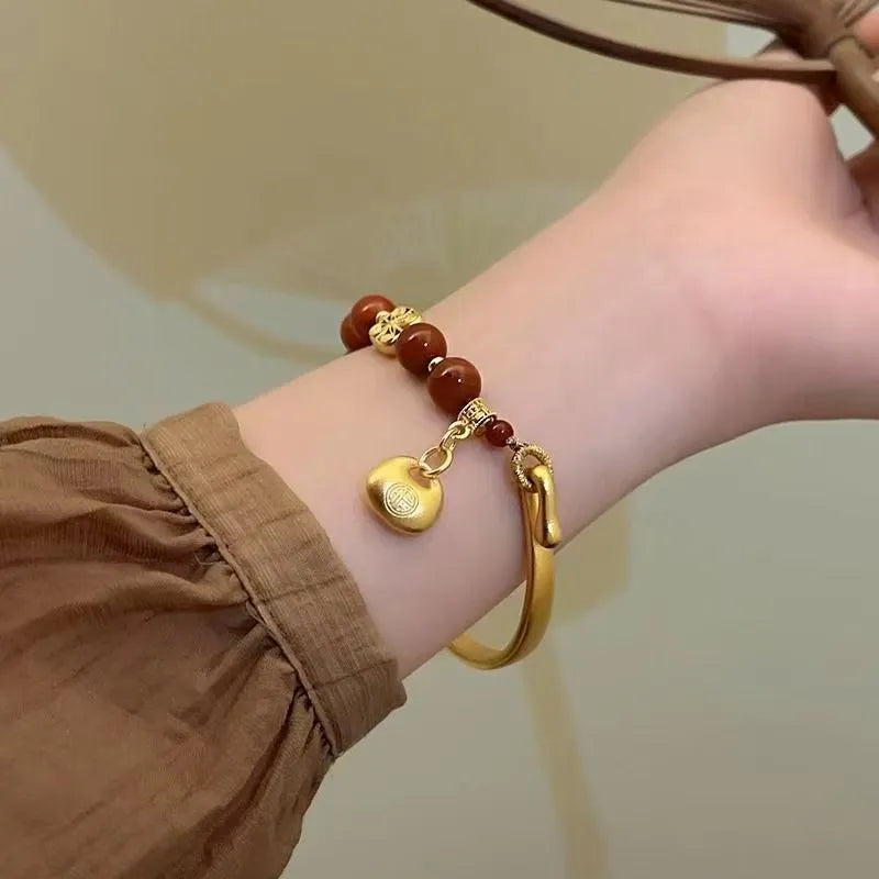Golden south red agate character ingot bracelet with lucky bag charm design for women