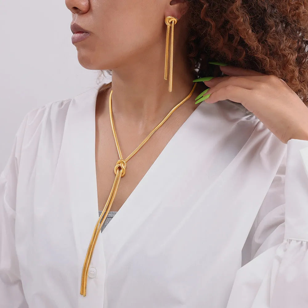Gold-plated titanium steel necklace with knotted tassel pendant and matching earrings