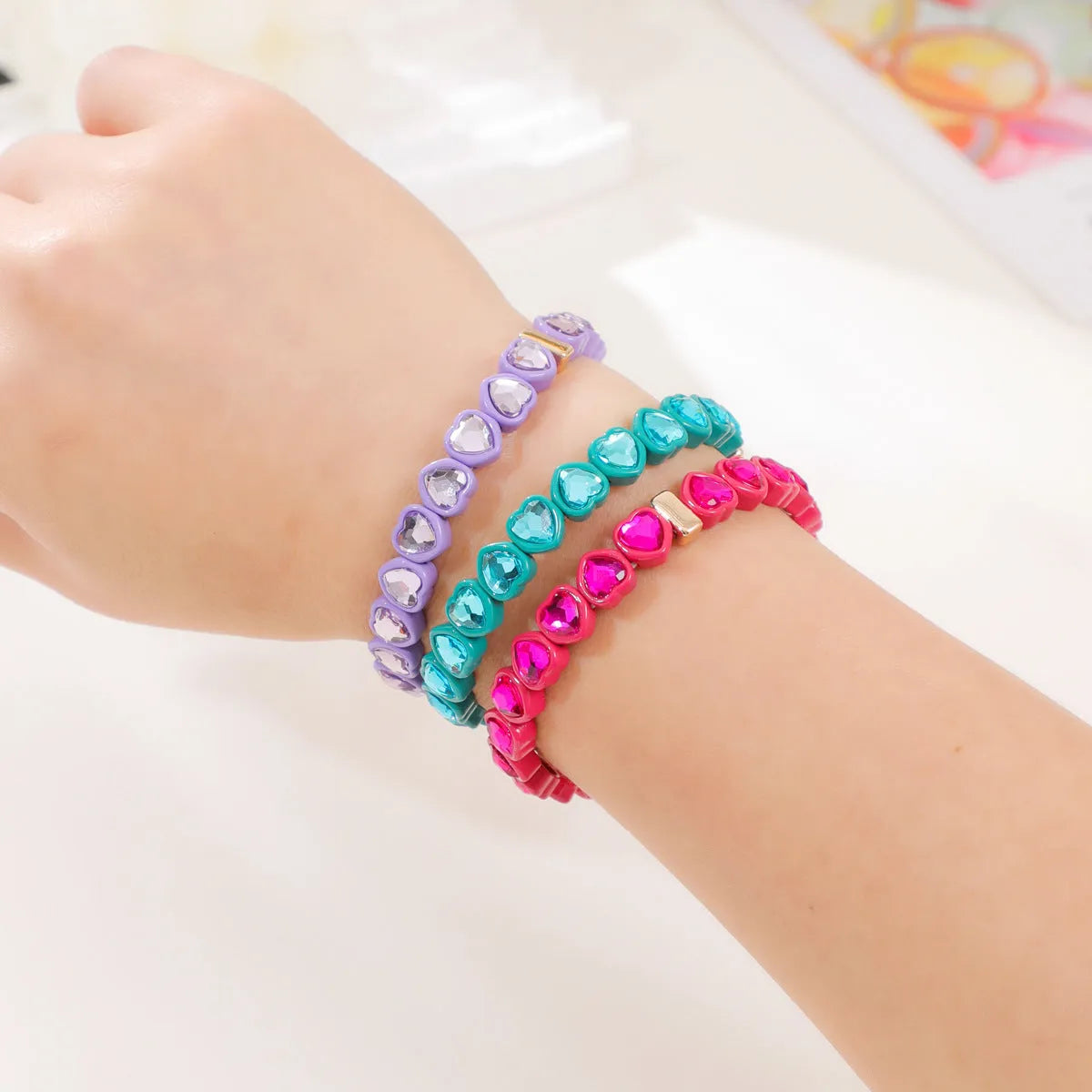 Rainbow coloured enamel heart pendant on stretch bracelet band