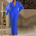 Red long-sleeve jumpsuit with mesh stitching detail, slim fit, wide legs, and an elastic waistband.