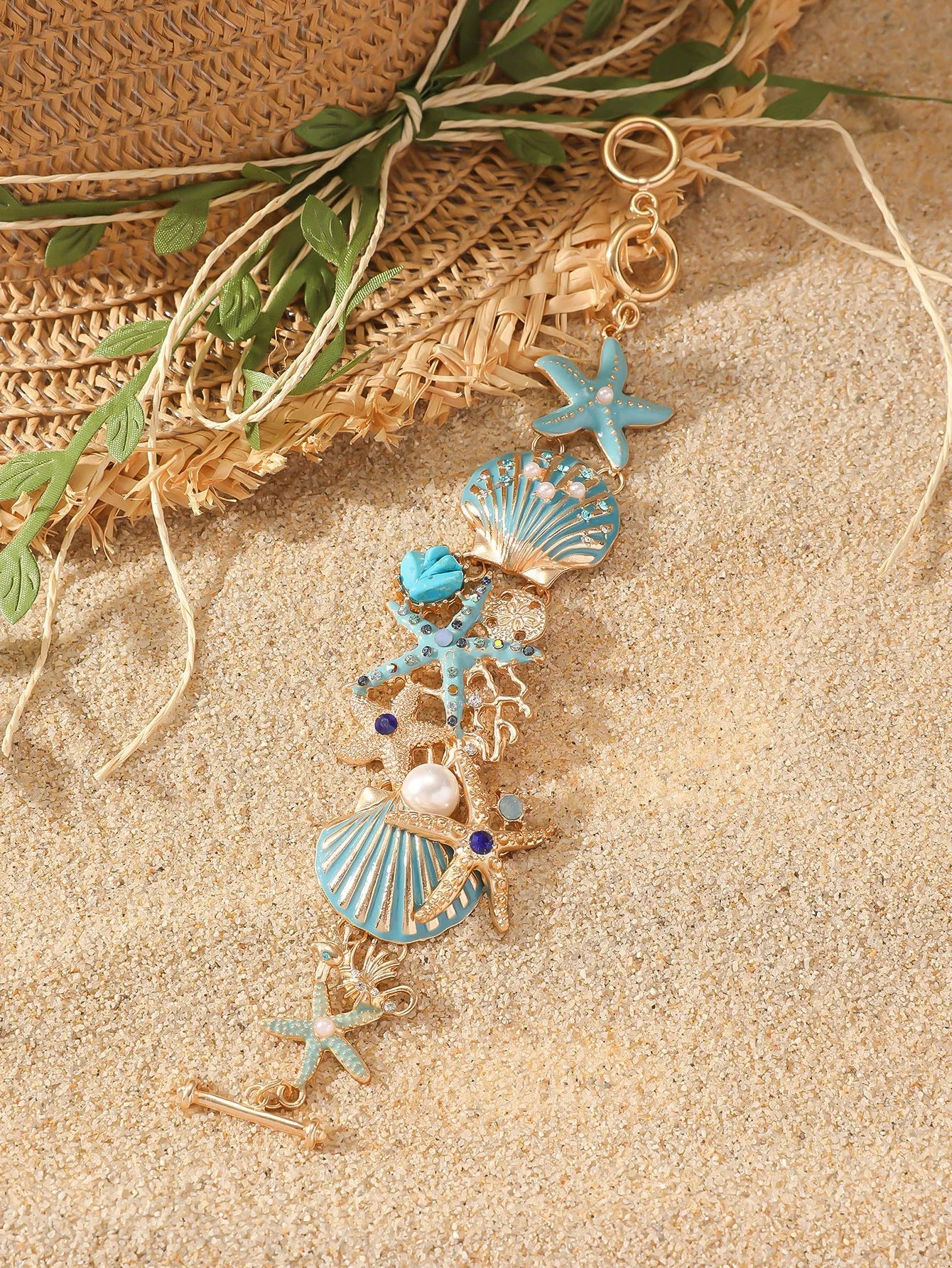 Alloy rhinestone bracelet with boat anchor, marine shell, and starfish charms in blue, red, or turquoise.