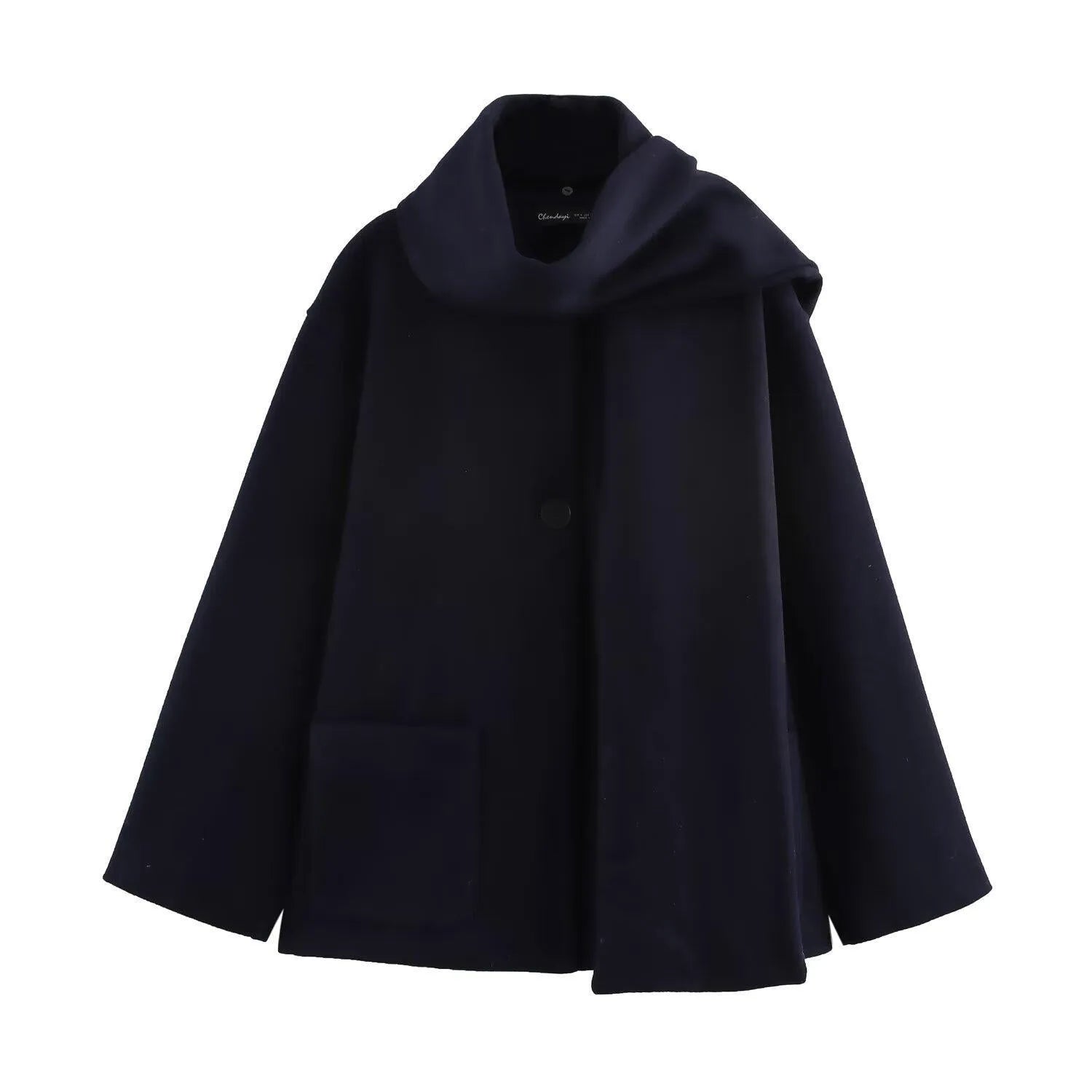 Women's long grey overcoat with artificial fur collar and pockets on a street-style backdrop.