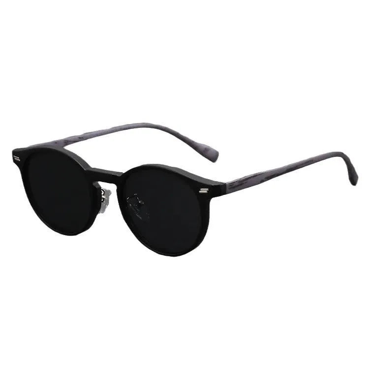 Retro round frosted sunglasses in leopard print and sand colours on a patterned background.