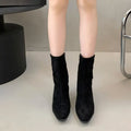 Brown square toe ankle boot with side zipper and a low kitten heel on a waterproof platform sole.