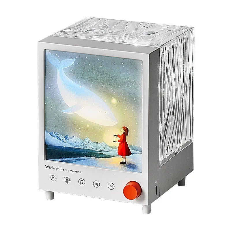 Aurora Treasure Box Star Sea Whale atmosphere projection lamp with Bluetooth speaker on a table.